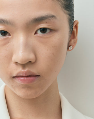 Model wears Madison 1ct oval cut diamond studs in 18ct white gold