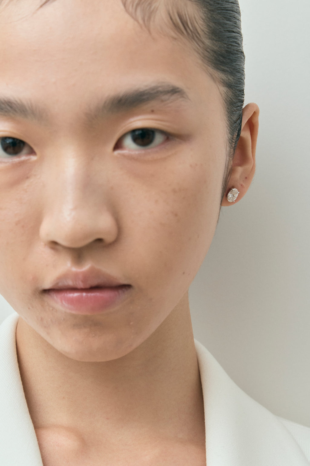 Model wears Madison 1ct oval cut diamond studs in 18ct white gold