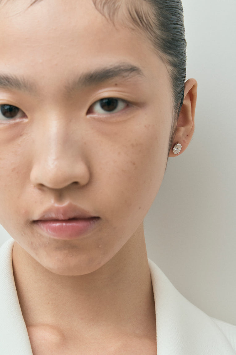 Model wears Madison 1ct oval cut diamond studs in 18ct white gold