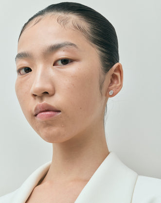 Model wears Madison 1ct oval cut diamond studs in 18ct white gold