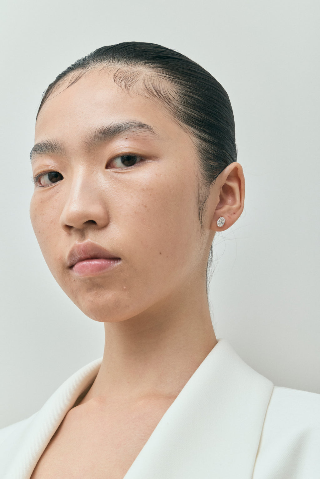 Model wears Madison 1ct oval cut diamond studs in 18ct white gold