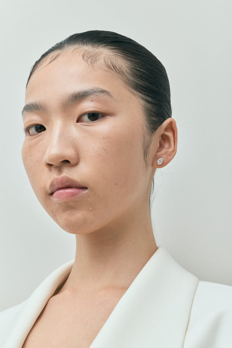 Model wears Madison 1ct oval cut diamond studs in 18ct white gold