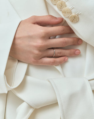 Model wears Cambon 1.8mm fine plain wedding band in 18ct white gold