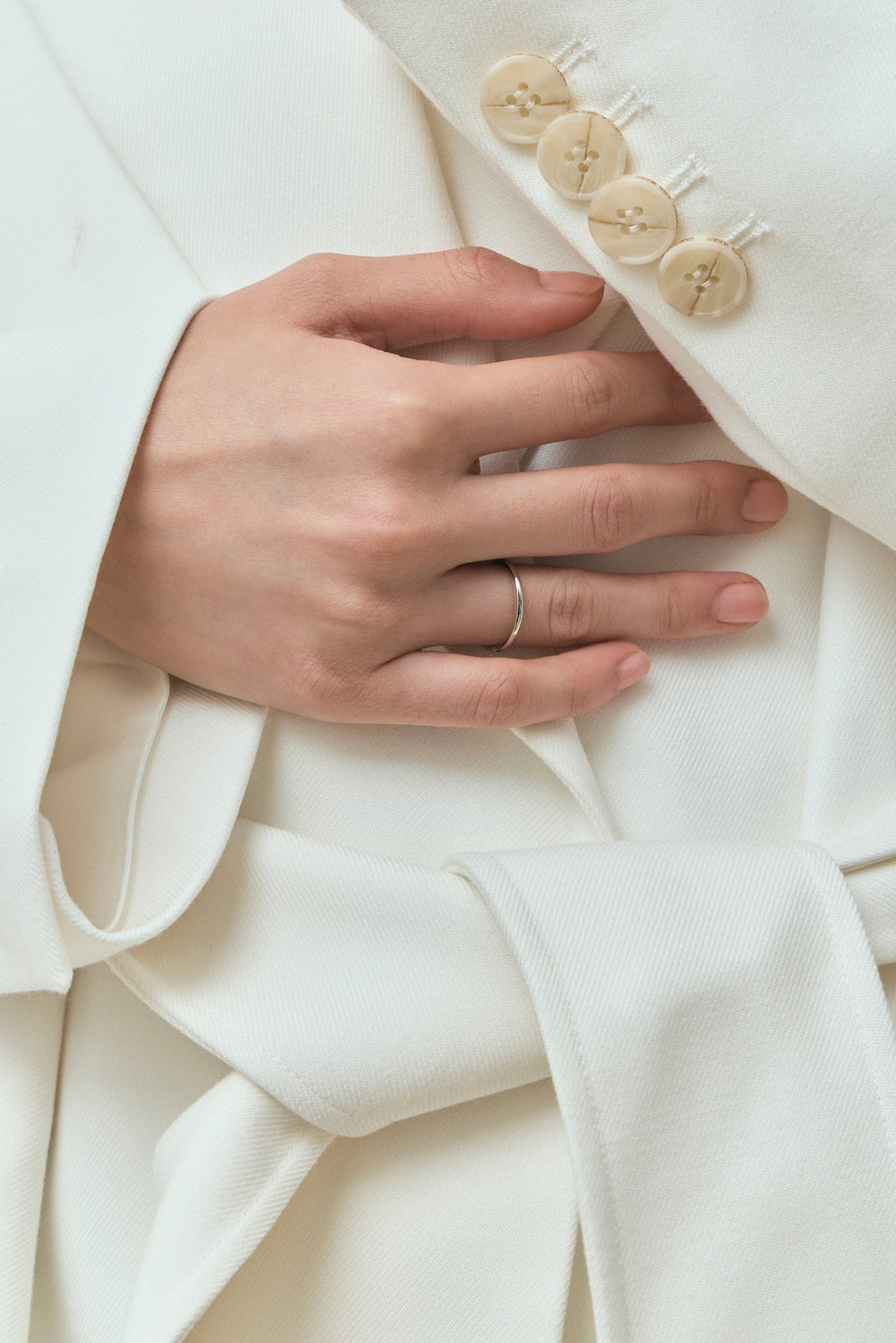Model wears Cambon 1.8mm fine plain wedding band in 18ct white gold
