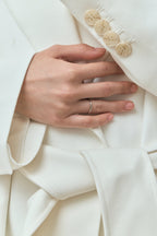 Model wears Cambon 1.8mm fine plain wedding band in 18ct white gold