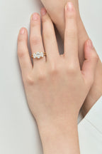 Model wears Clarkson oval trilogy engagement ring in 18ct yellow gold