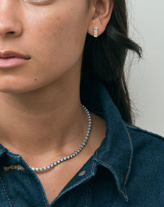 Model wears Charlot double 0.50ct emerald cut drop earrings in 18ct yellow gold