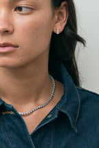 Model wears Charlot double 0.50ct emerald cut drop earrings in 18ct yellow gold