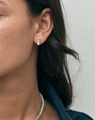 Model wears Charlot double 0.50ct emerald cut drop earrings in 18ct yellow gold