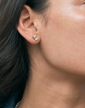 Model wears Chelsea 1ct emerald cut diamond studs in 18ct white gold