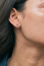 Model wears Chelsea 1ct emerald cut diamond studs in 18ct white gold