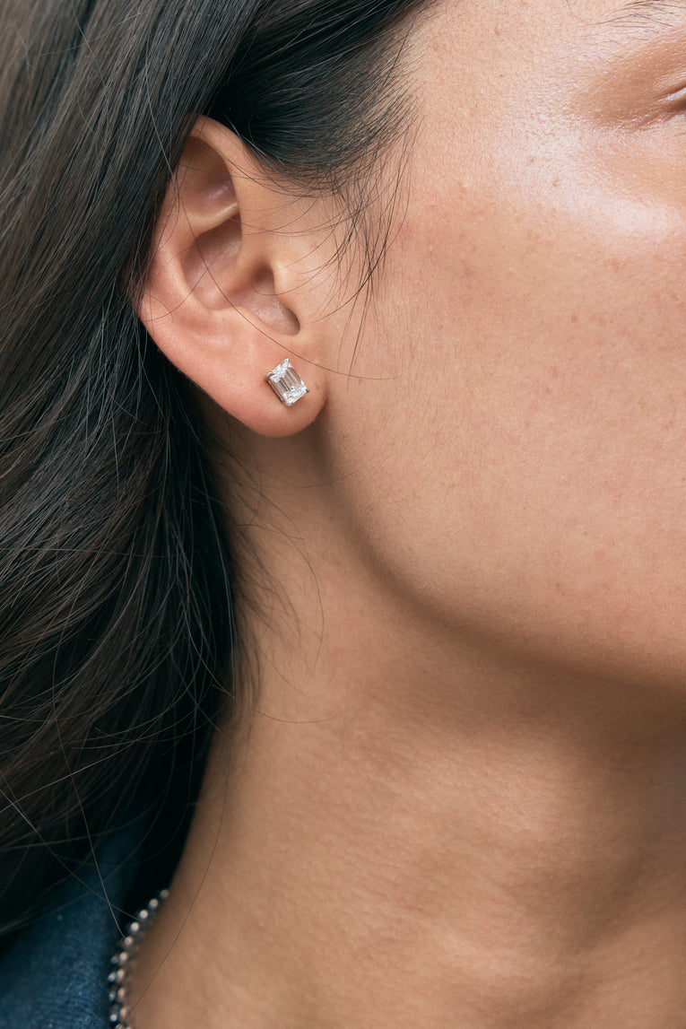 Model wears Chelsea 1ct emerald cut diamond studs in 18ct white gold