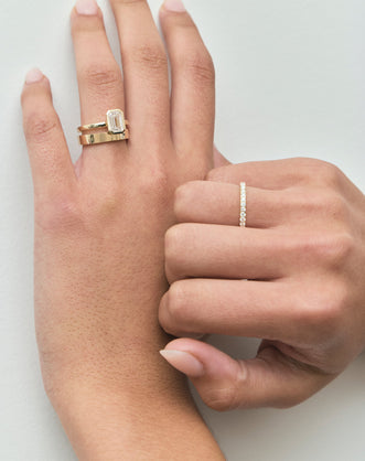 Close-up Sutton emerald cut solitaire bezel north-south engagement ring in 18ct yellow gold