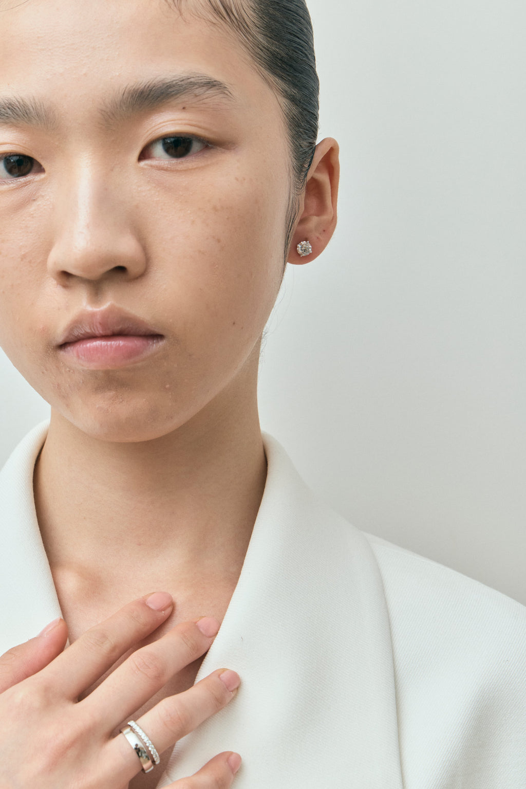 Model wears Dean 1ct round brilliant cut diamond studs in 18ct white gold