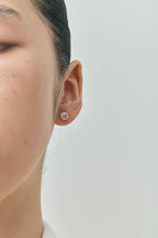 Model wears Dean 1ct round brilliant cut diamond studs in 18ct white gold