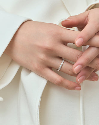 Model wears Paddington 2.4mm round brilliant half set wedding band in 18ct white gold