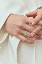Model wears Paddington 2.4mm round brilliant half set wedding band in 18ct white gold