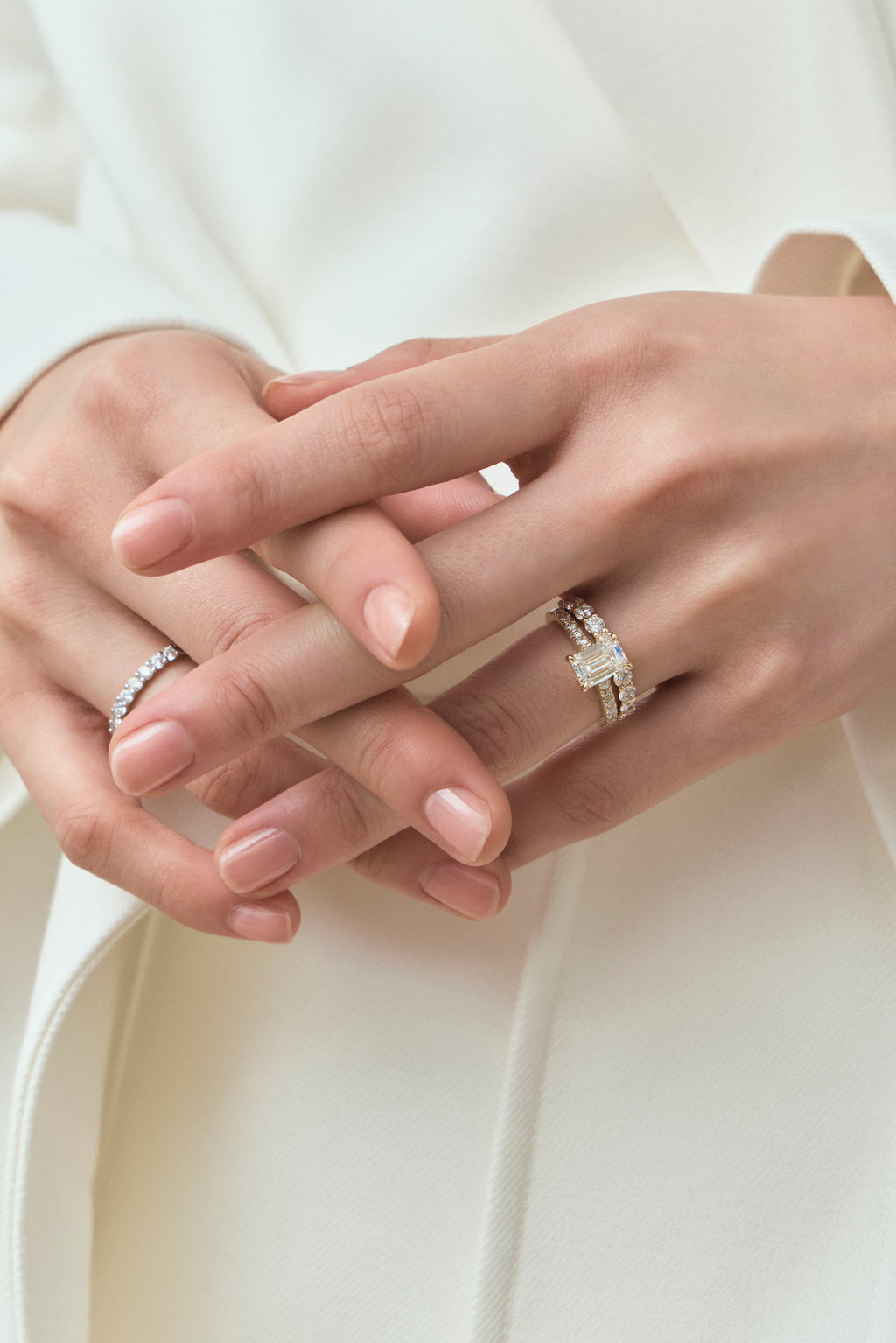 Model wears Beverly emerald cut diamond band engagement ring in 18ct yellow gold 