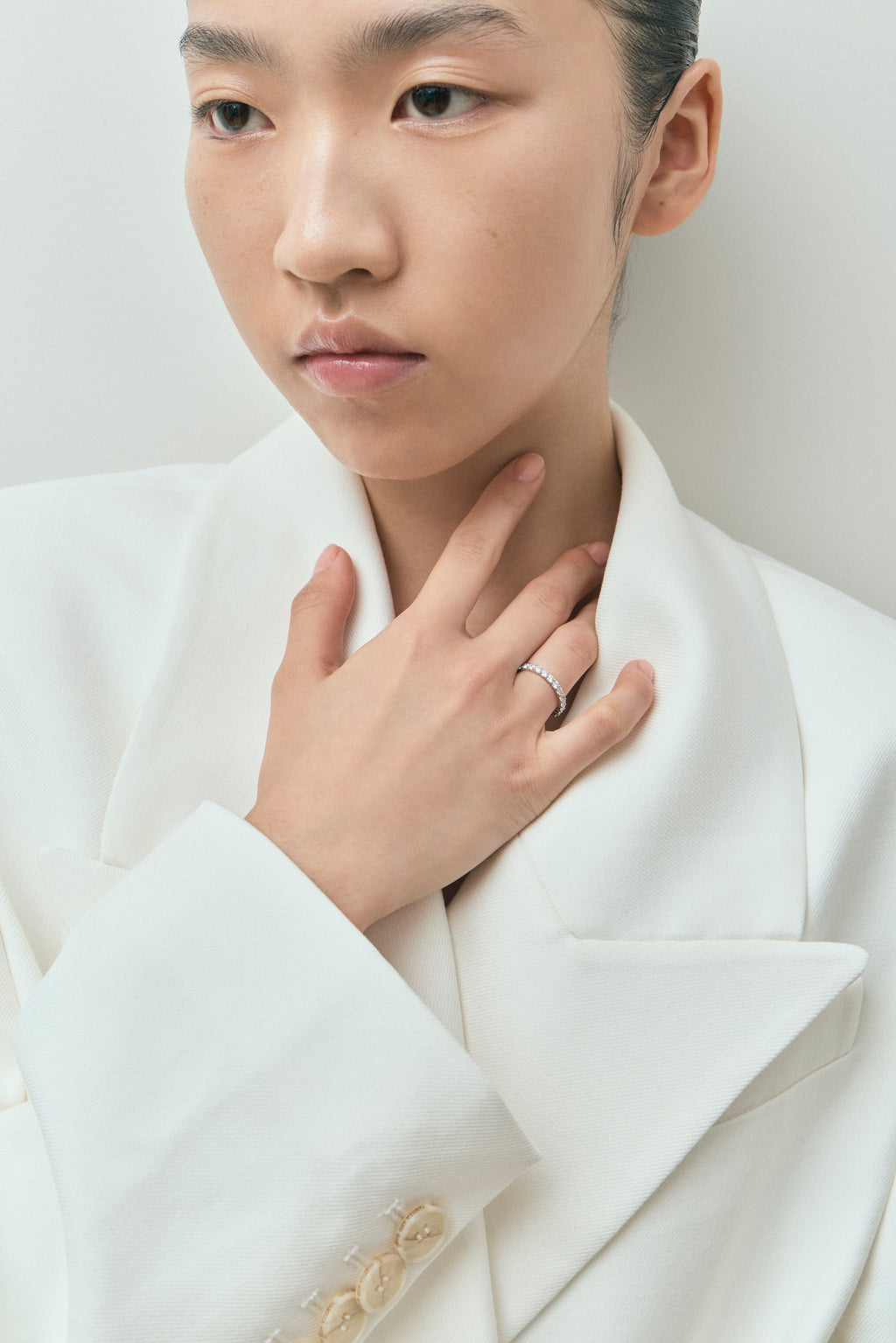 Model wears Paddington 2.4mm round brilliant half set wedding band in platinum