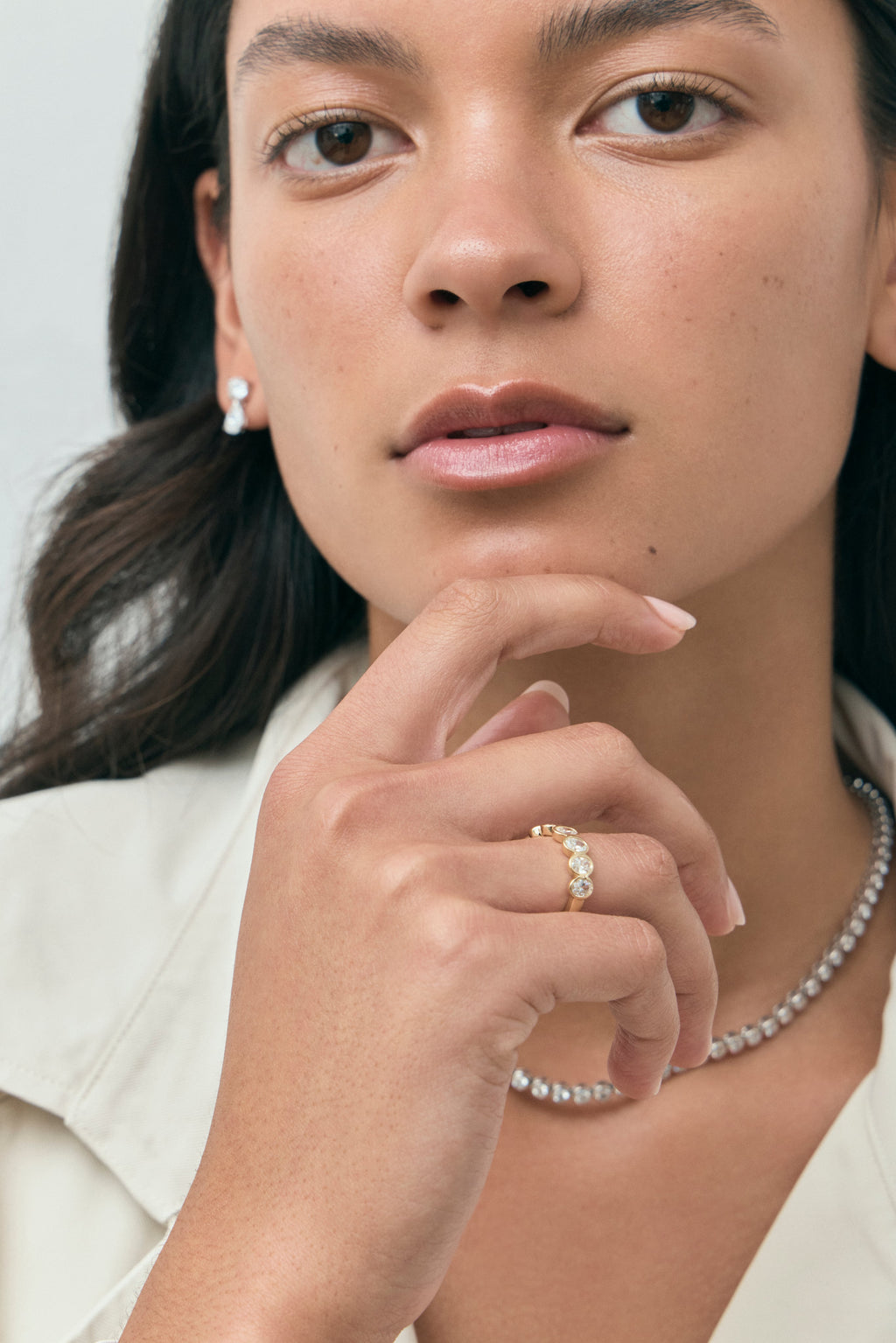 Model wears Tournon 0.20ct oval bezel set half eternity band in 18ct yellow gold