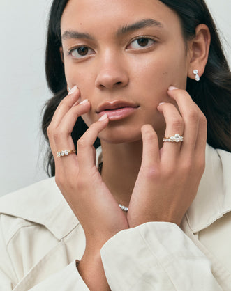Model wears Bonaparte oval pear side stone engagement ring in 18ct yellow gold