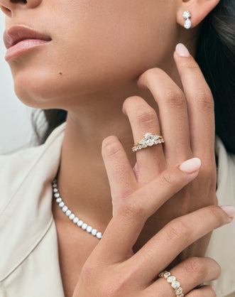 Model wears Hastings 0.10ct oval East-West half set wedding band in 18ct yellow gold