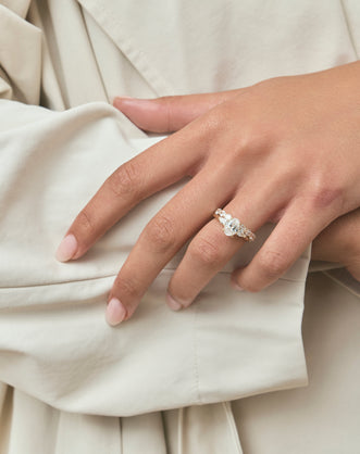 Close-up Bonaparte oval pear side stone engagement ring in 18ct yellow gold