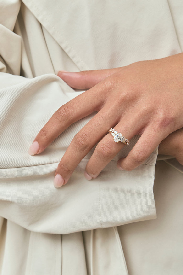 Close-up Bonaparte oval pear side stone engagement ring in 18ct yellow gold