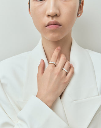 Model wears Melrose 0.50ct heart shape half eternity band in platinum on yellow gold