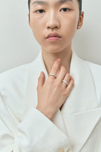Model wears Melrose 0.50ct heart shape half eternity band in platinum on yellow gold