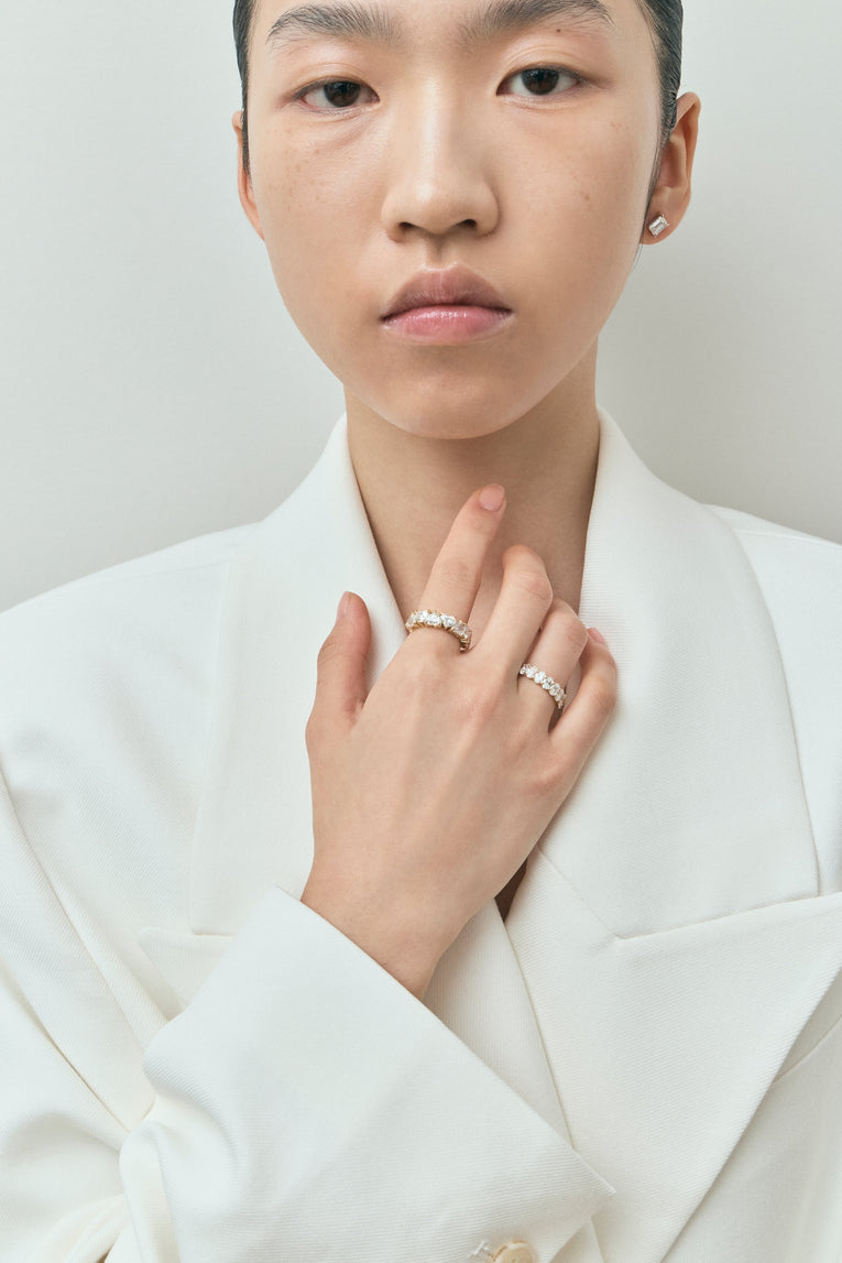 Model wears Melrose 0.50ct heart shape half eternity band in platinum on yellow gold