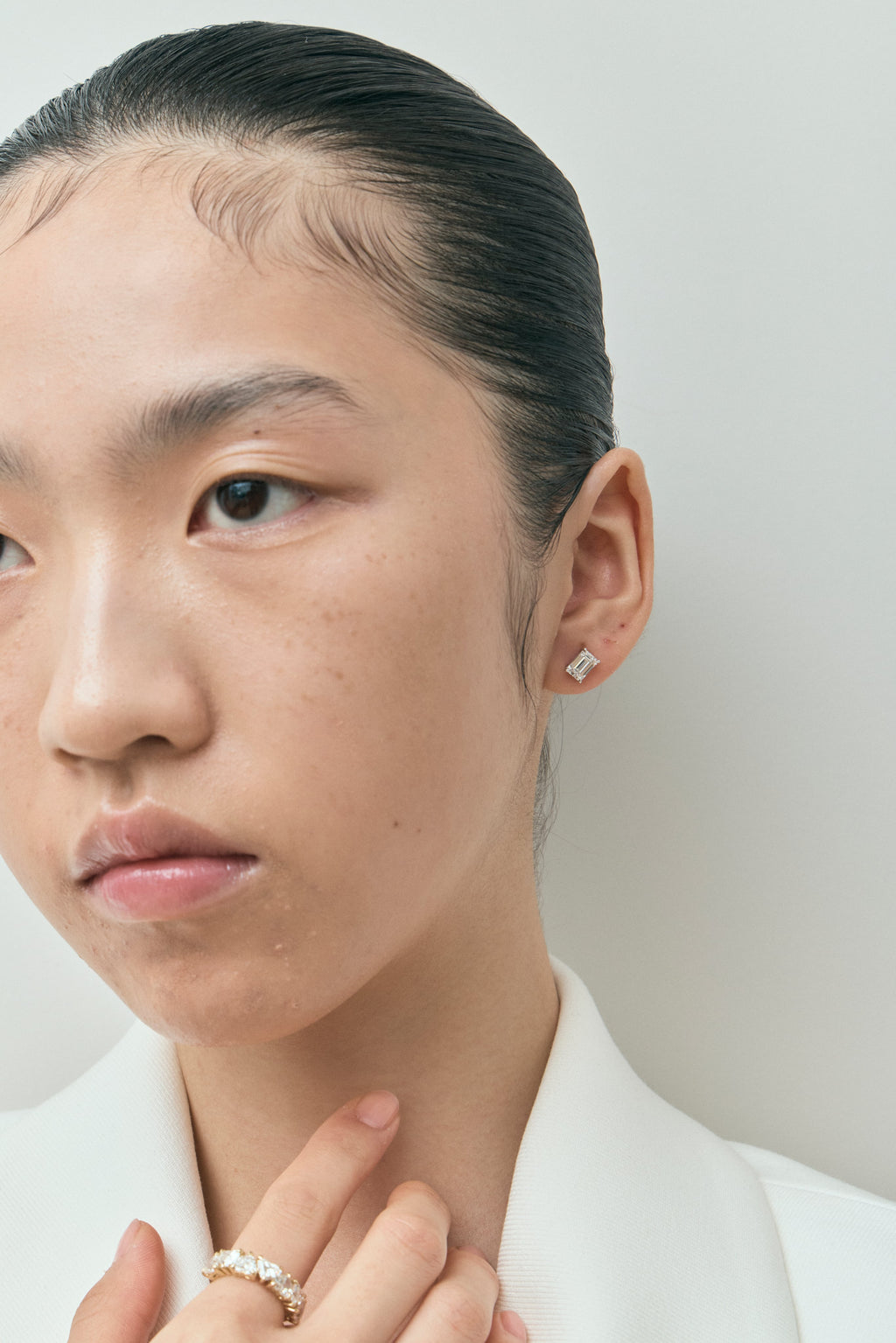 Model wears Chelsea 1ct emerald cut diamond studs in 18ct white gold