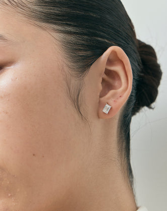 Model wears Chelsea 1ct emerald cut diamond studs in 18ct white gold