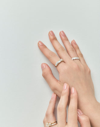 Model wears Melrose 0.50ct heart shape half eternity band in 18ct yellow gold