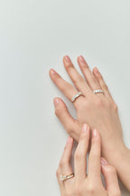 Model wears Melrose 0.50ct heart shape half eternity band in 18ct yellow gold