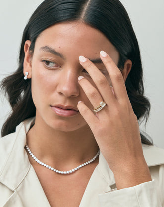 Model wears Lexington emerald cut solitaire classic engagement ring in 18ct yellow gold