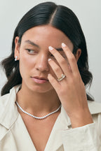 Model wears Lexington emerald cut solitaire classic engagement ring in 18ct yellow gold
