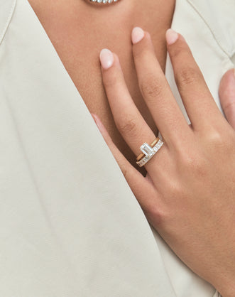 Model wears Lexington emerald cut solitaire classic engagement ring in 18ct yellow gold