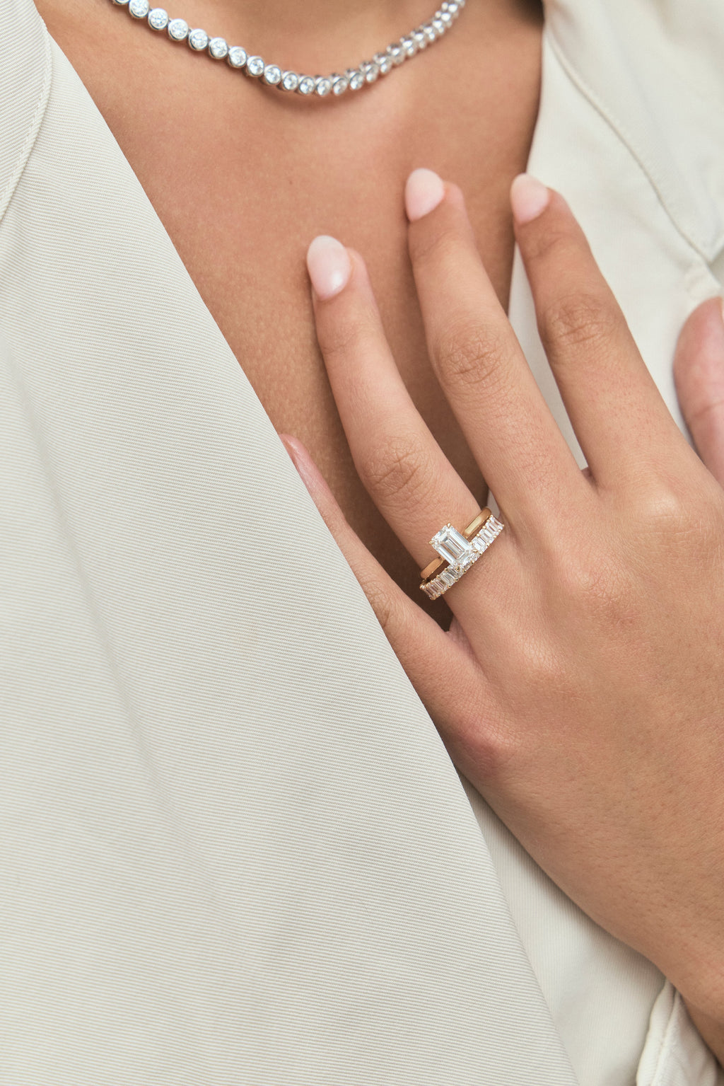 Model wears Lexington emerald cut solitaire classic engagement ring in 18ct yellow gold