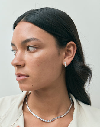 Model wears Saville 0.50ct round brilliant pear cut drop earrings in 18ct white gold