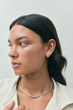 Model wears Saville 0.50ct round brilliant pear cut drop earrings in 18ct white gold