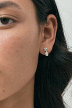 Model wears Saville 0.50ct round brilliant pear cut drop earrings in 18ct white gold