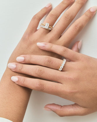 Model wears Lexington emerald cut solitaire classic engagement ring in 18ct yellow gold