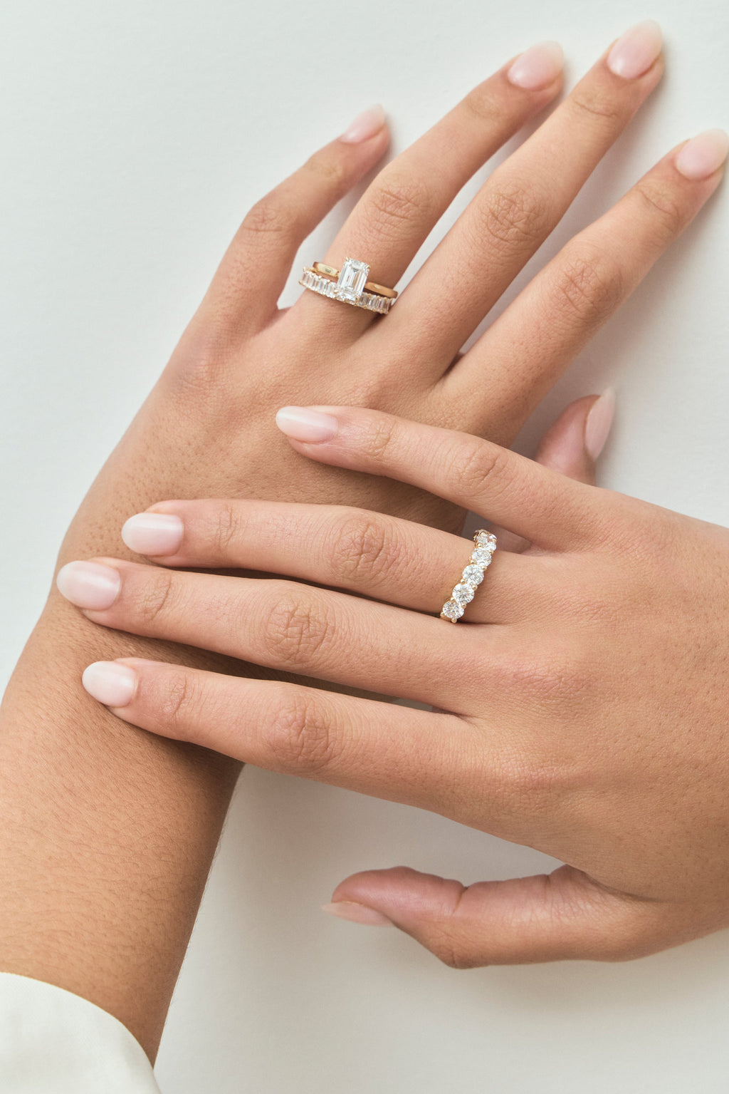 Model wears Lexington emerald cut solitaire classic engagement ring in 18ct yellow gold