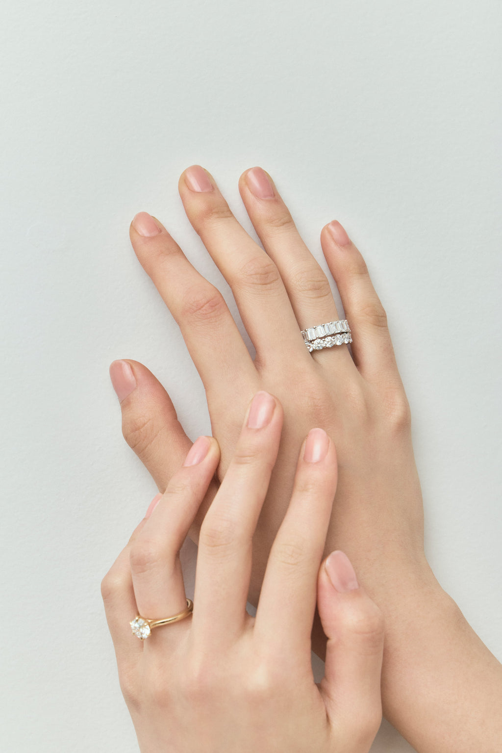 Close-up model wears Soho 0.20ct emerald cut half eternity band in platinum