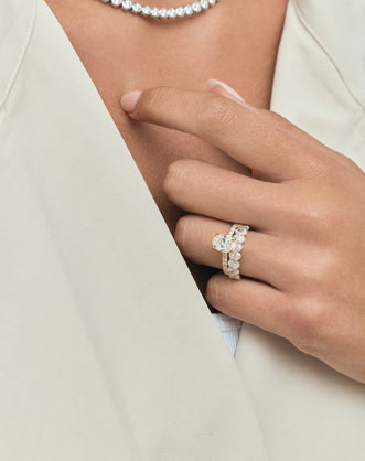 Close-up model wears Cler 0.20ct oval half eternity band in 18ct yellow gold