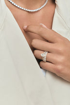 Close-up model wears Cler 0.20ct oval half eternity band in 18ct yellow gold