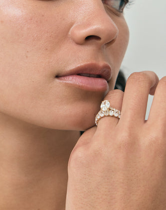 Model wears Nassau oval cut diamond band engagement ring in 18ct yellow gold