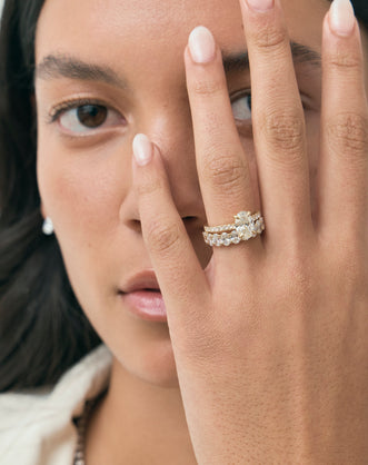 Model wears Nassau oval cut diamond band engagement ring in 18ct yellow gold