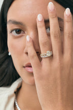 Model wears Nassau oval cut diamond band engagement ring in 18ct yellow gold